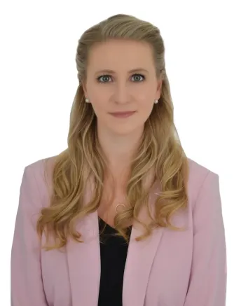 staff member working at TPTC, standing posing for a professional picture wearing a professional outfit.